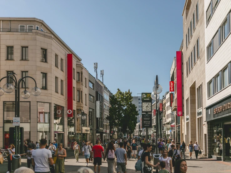 a crowd of people walking down the side walk