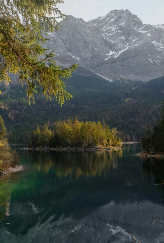 the water is reflecting mountains in the background