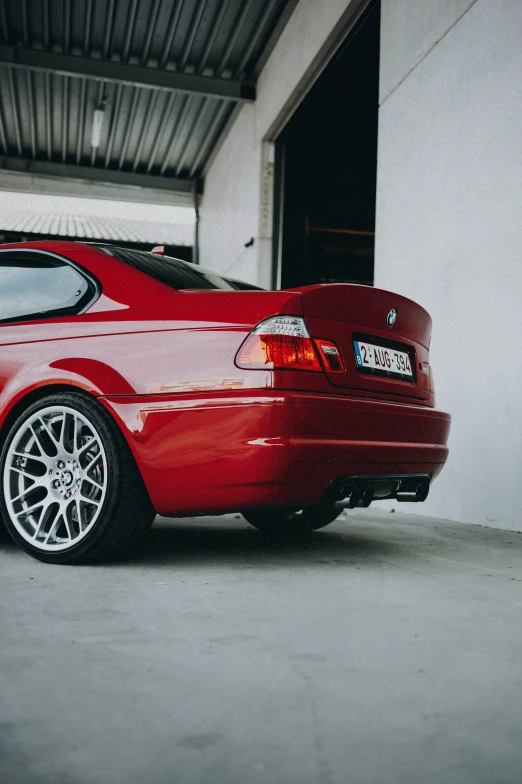 a close up of the rear end of a red car