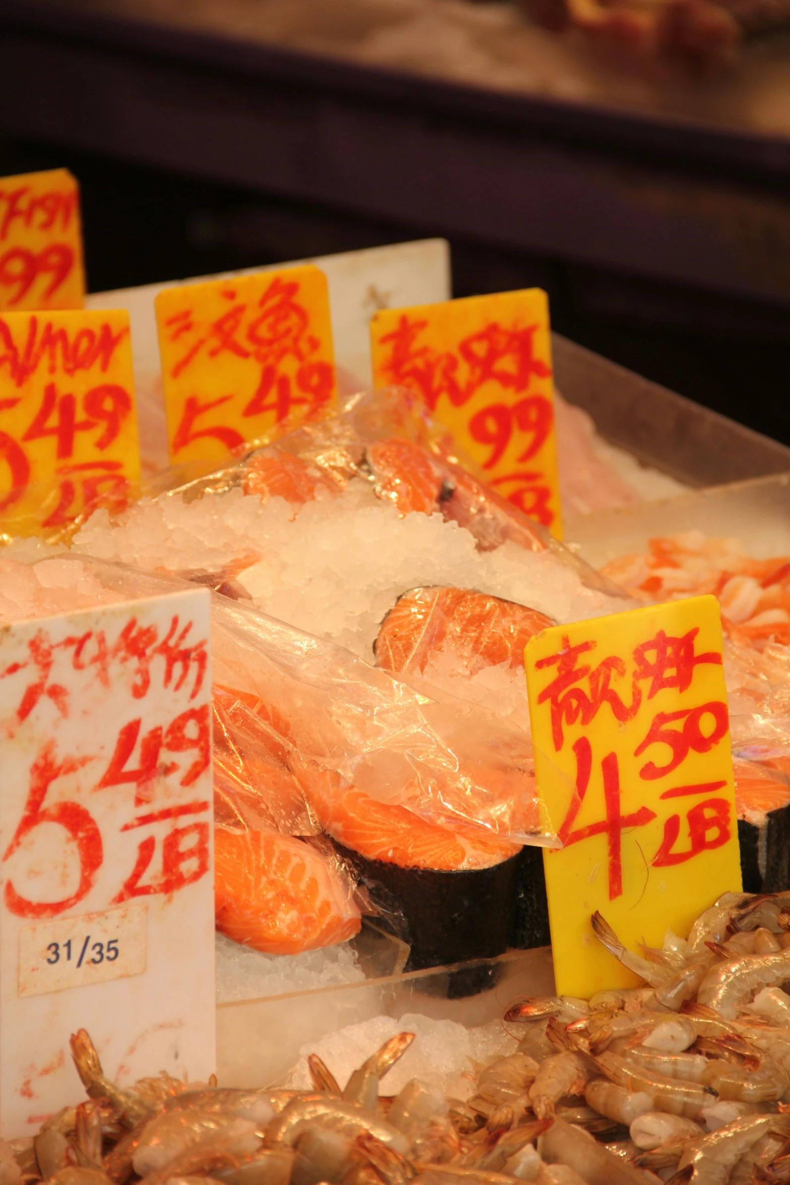 several signs on various items for sale at the market