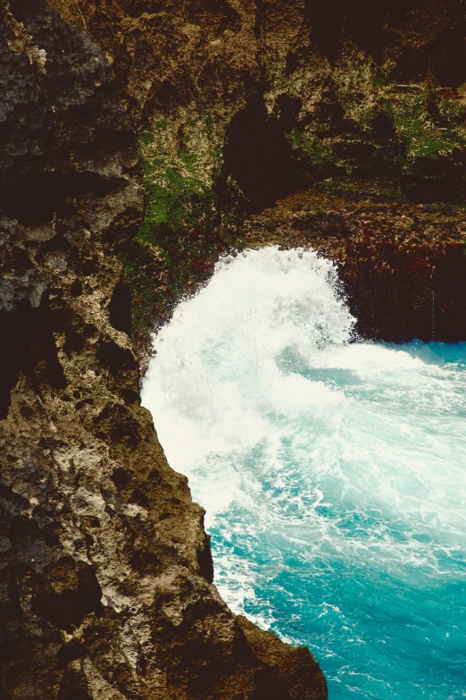 this is the view of some waves crashing into a rock