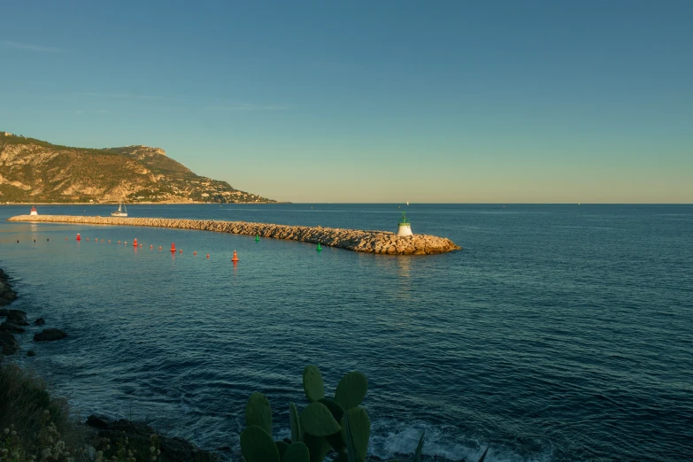 a body of water with several rocks in it and one on a small shore