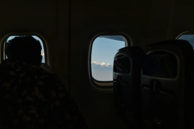 two people look out the windows as they fly