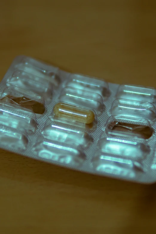 two pills lying next to each other on top of a table