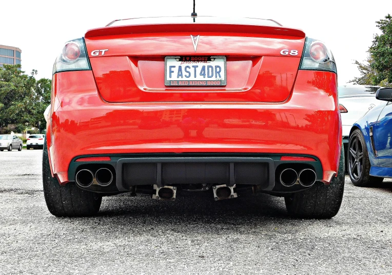 the rear end of a red sports car