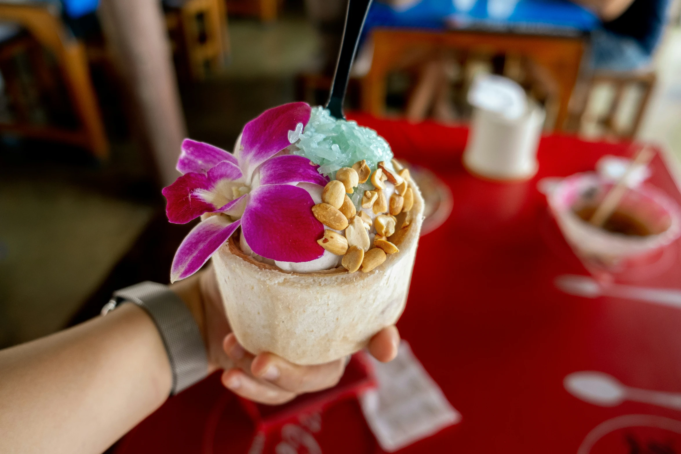 a ice cream cone is topped with colorful flowers