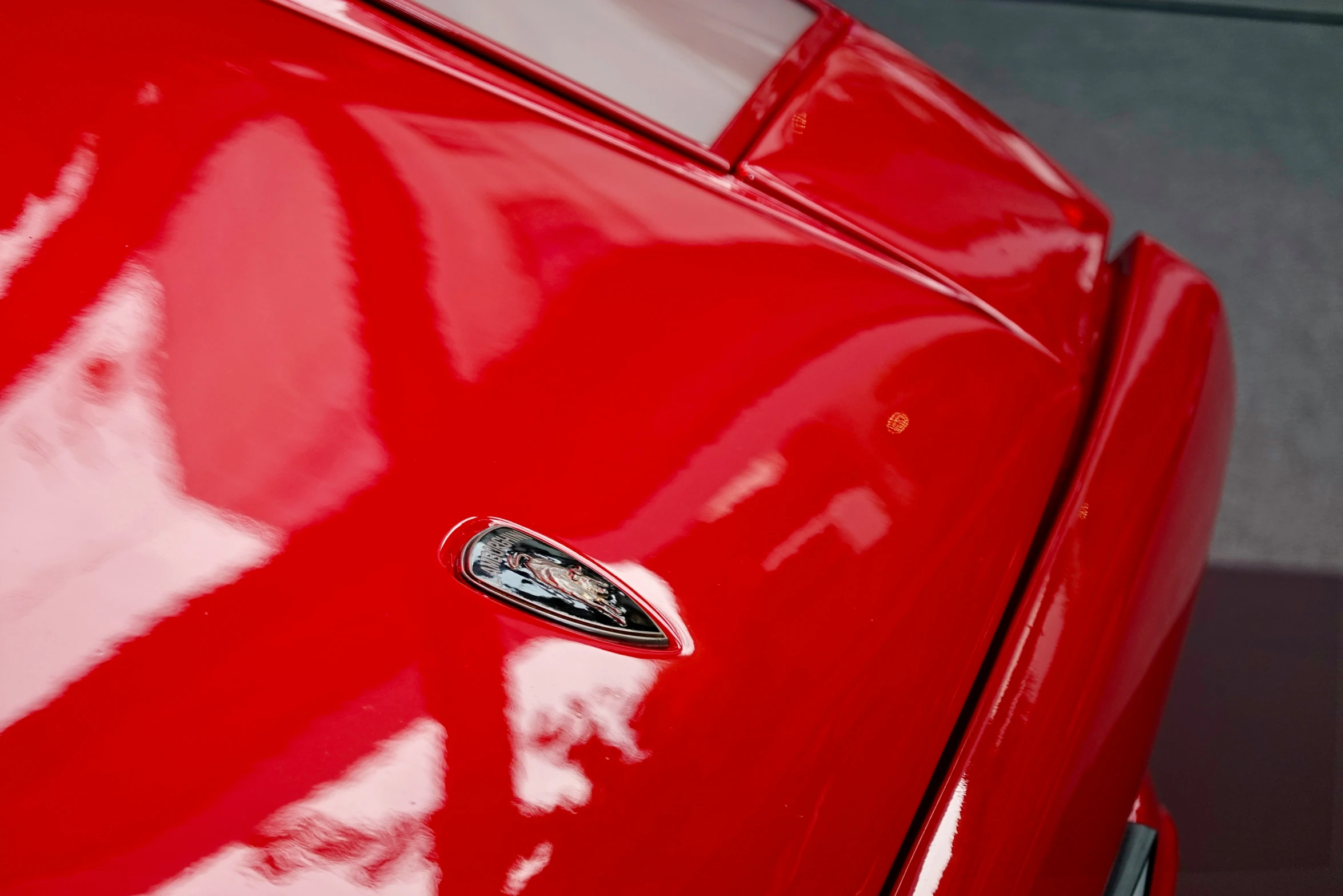 a red sports car with the emblem and emblem on it