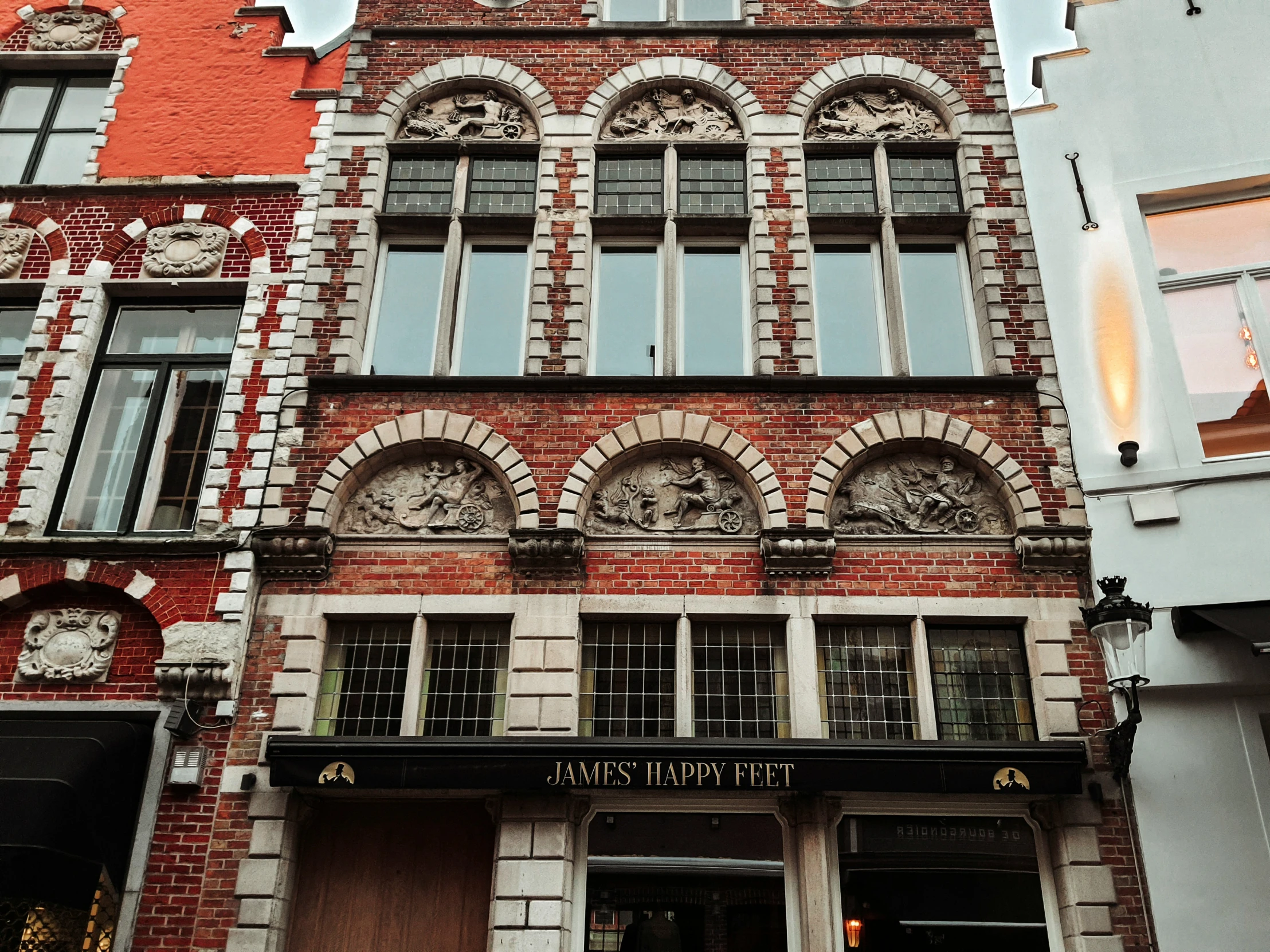 tall brick building with three clock faces on each of its windows