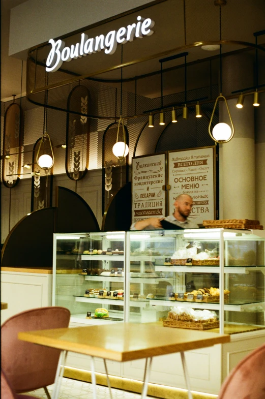 a bakery store with a man working behind the counter