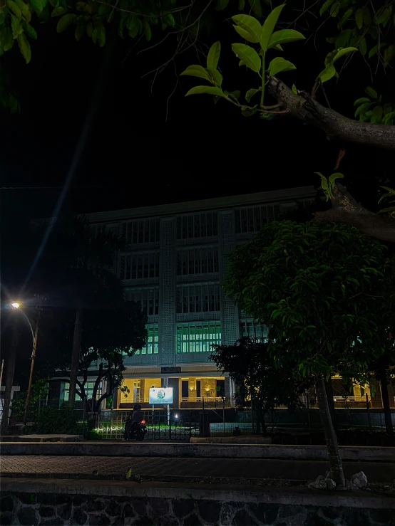 there is a green sign sitting near the street