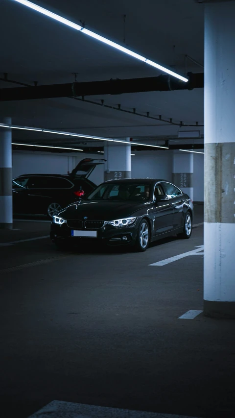 a parking garage has two cars parked in it