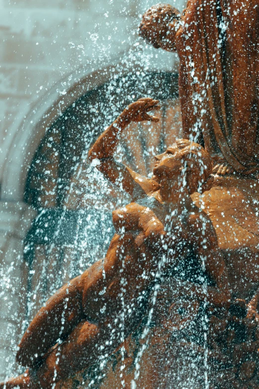 several teddy bears on a fountain in the rain