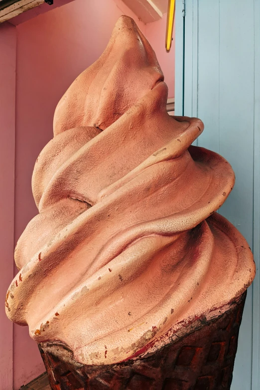 a huge piece of wooden art in the shape of a cone