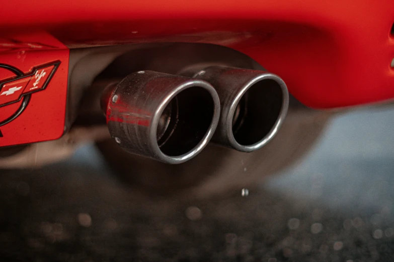 a pair of chrome exhaust pipe with a red cloth