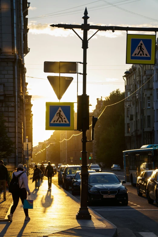 pedestrians, cars and trucks are travelling down a busy street