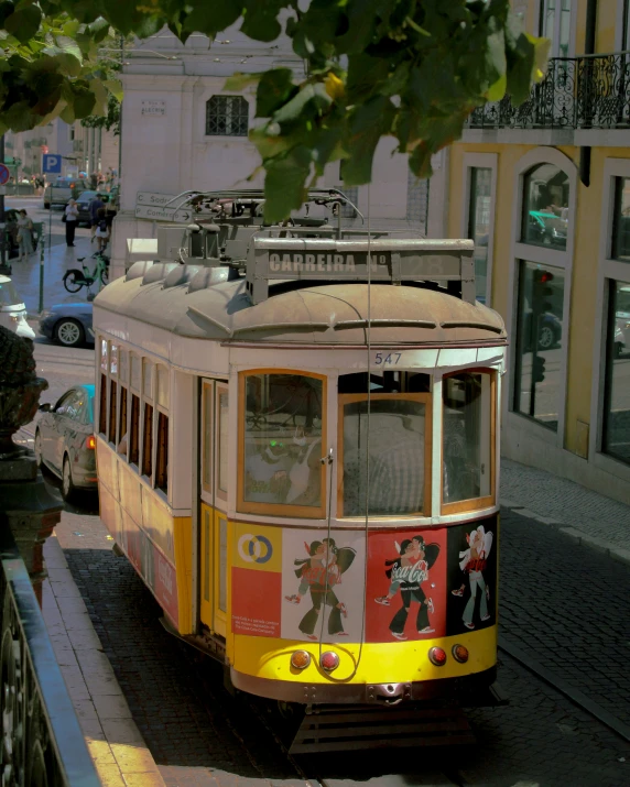 a street car is on the tracks down the street