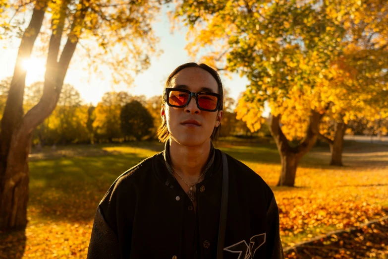 a man in red sunglasses poses for a po