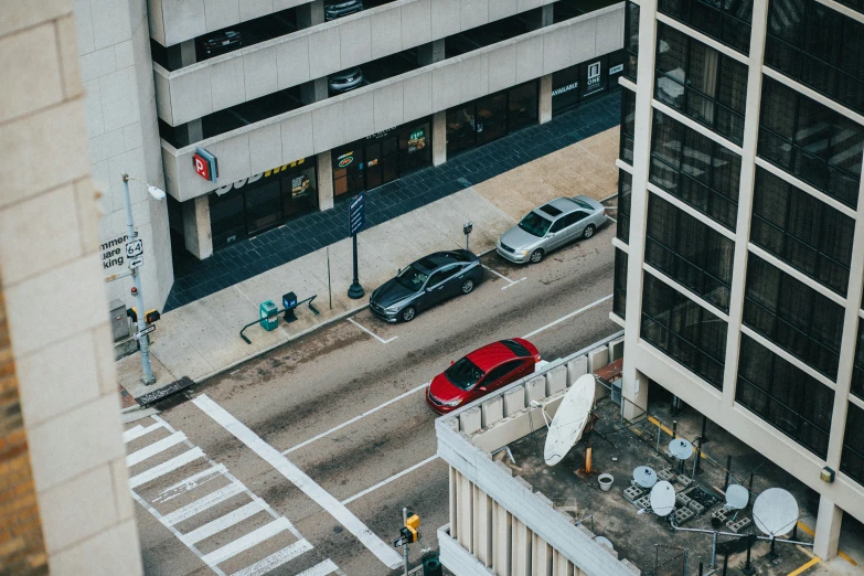 a city street has cars driving down the road