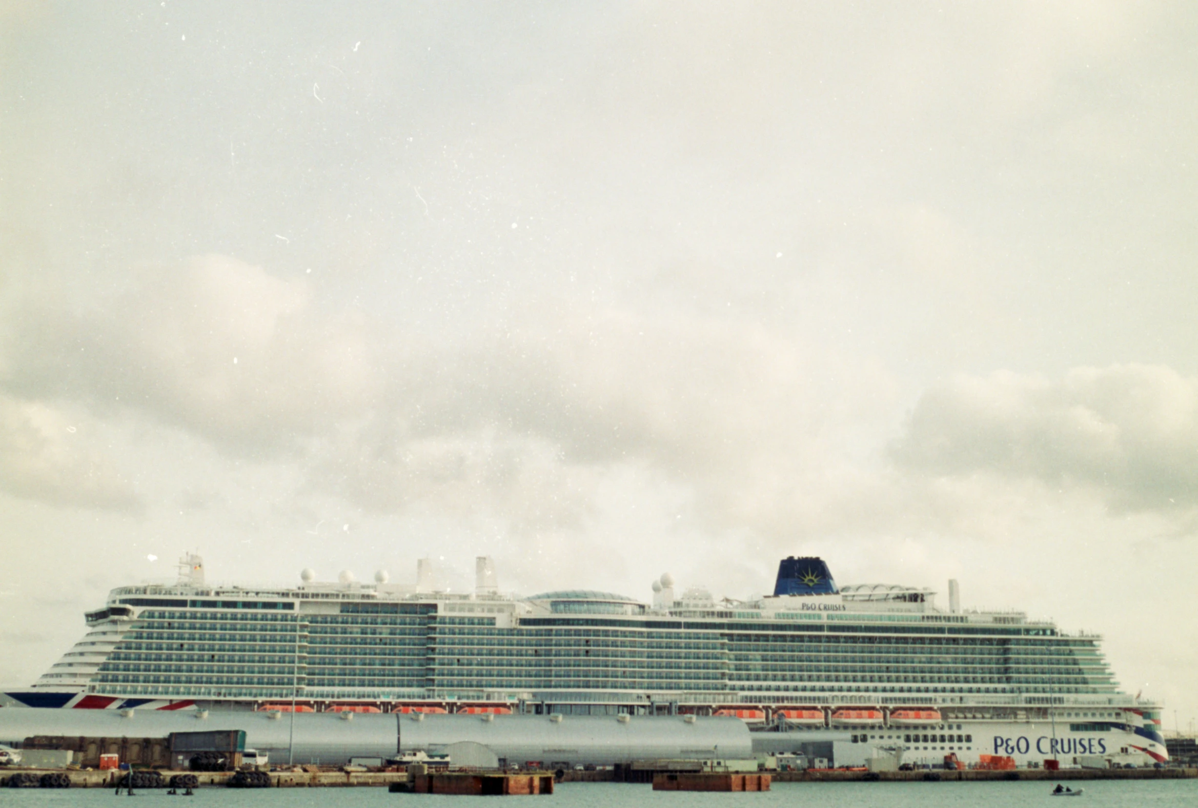 a cruise ship sitting in the water next to a dock