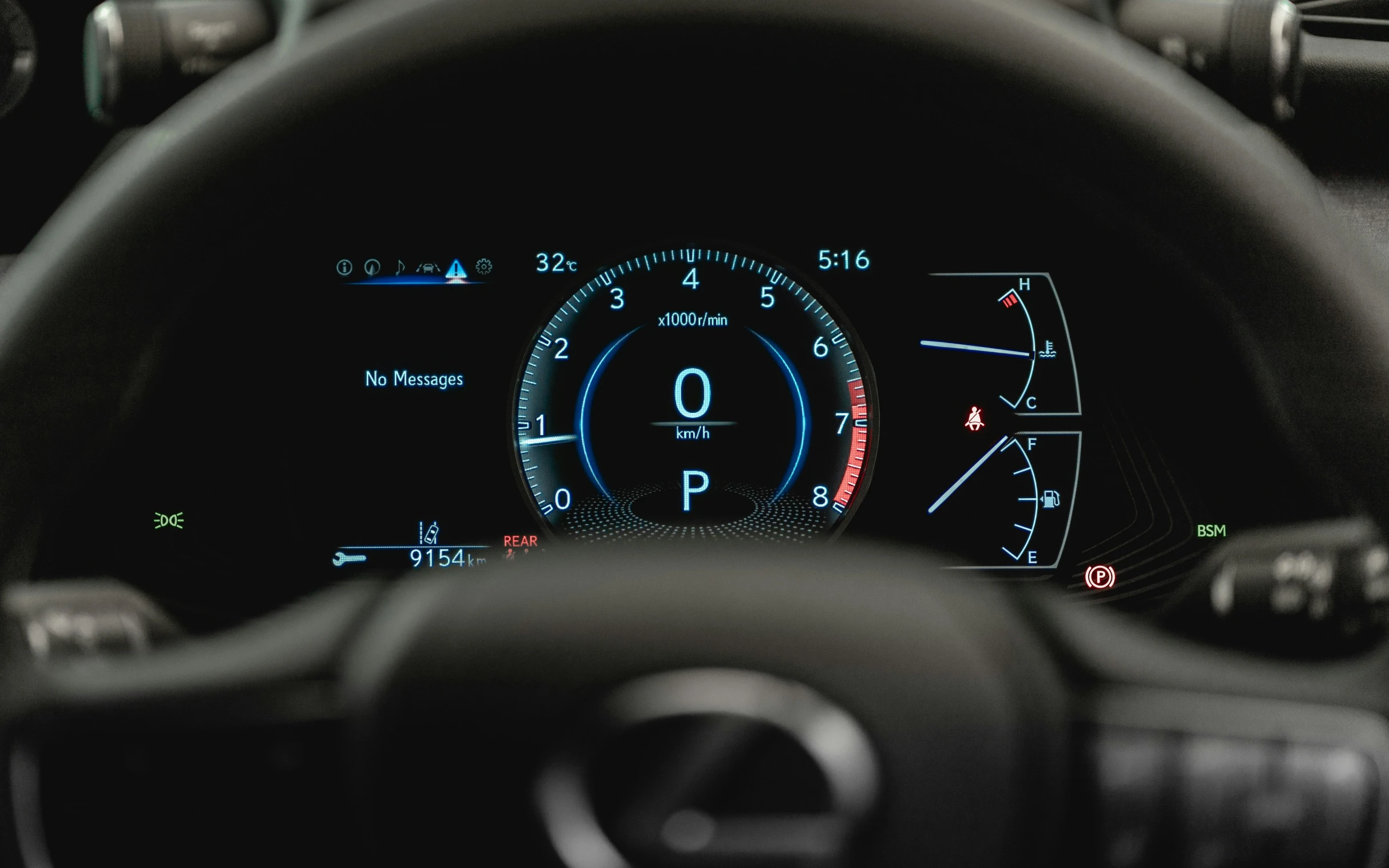 steering wheel and dashboard of a car showing dashboard lights and info