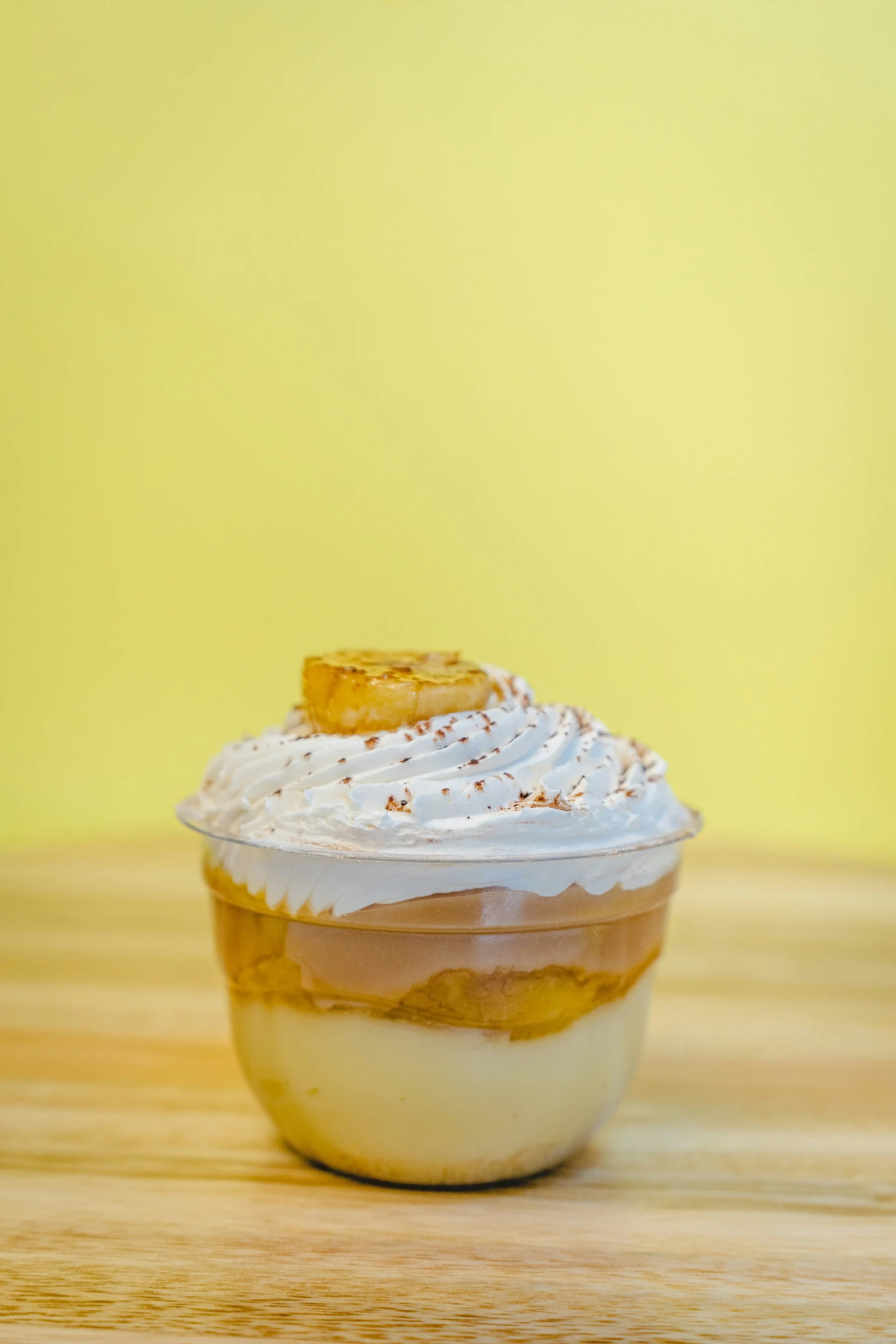 a cup cake is on top of a wooden table