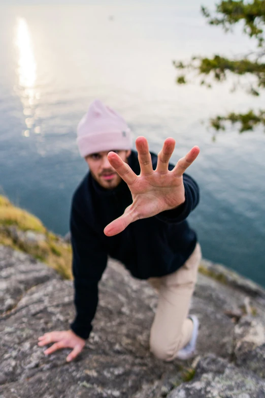 a man reaching down and touching his hand