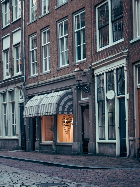 a street corner with a store front and buildings in the background