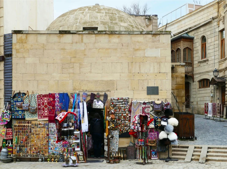 a man is selling a variety of items in the street