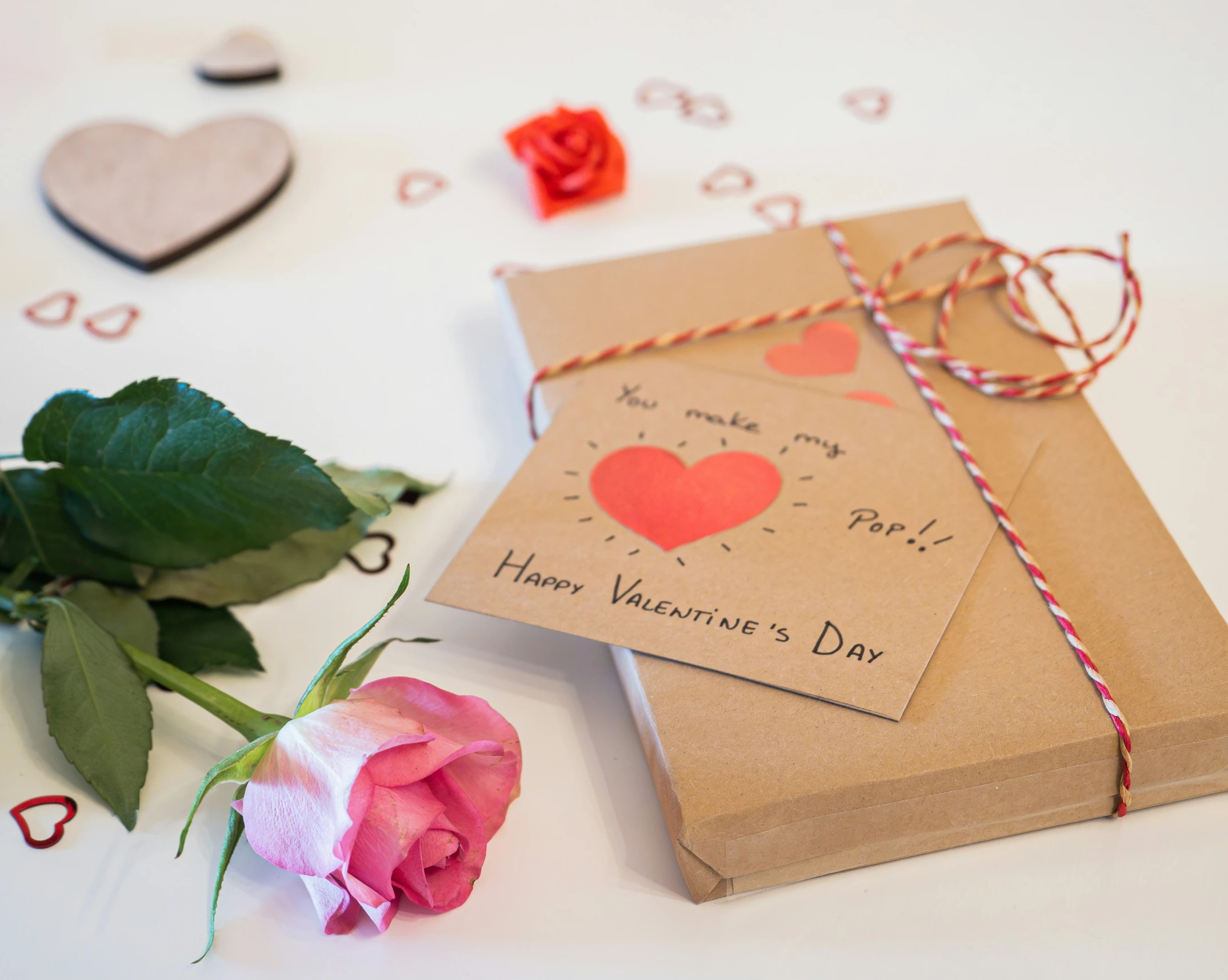 two brown packages with red and pink hearts are shown