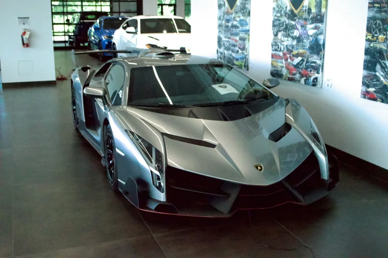 a silver and black car on display in a museum