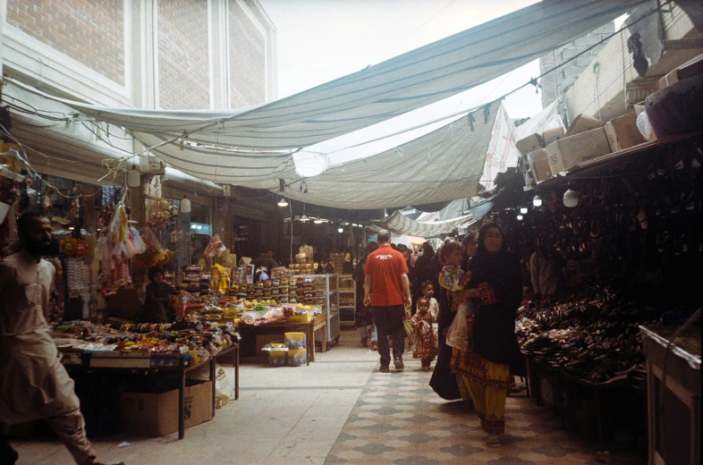 a man is walking through a busy market