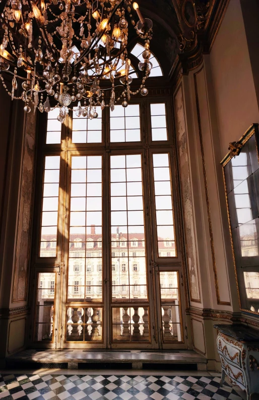 a room with large windows and a chandelier