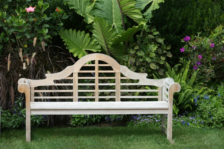 an old wood bench in the middle of a garden