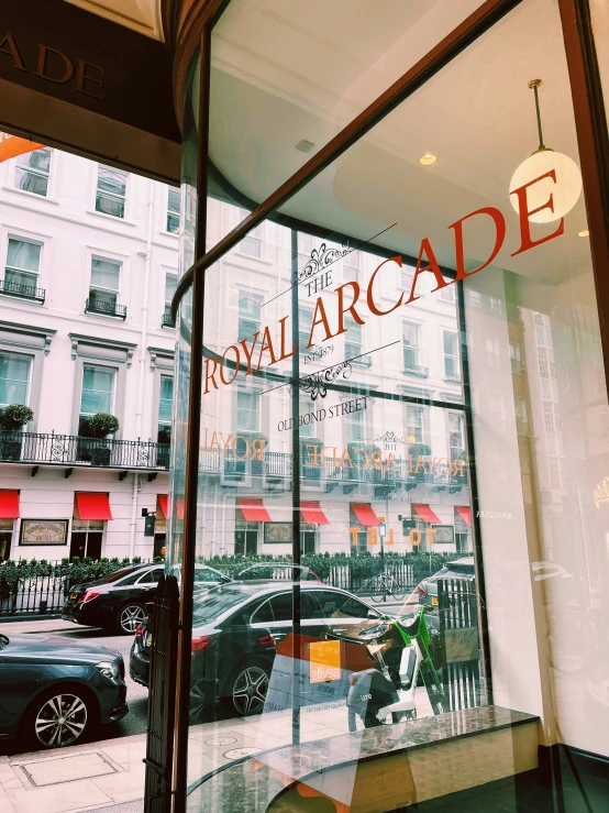 a store front window and street with cars