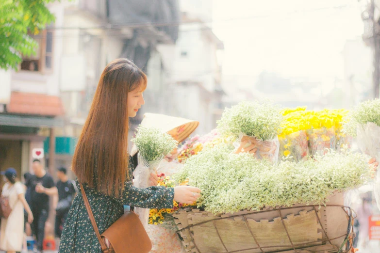 a girl with long hair holding a basket full of flowers