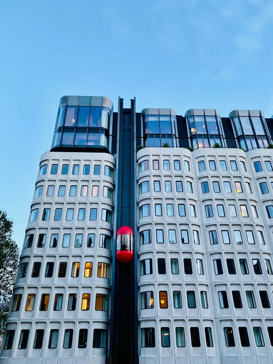 a large building with many windows near trees