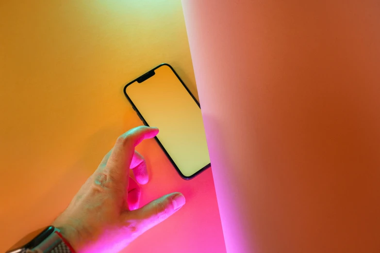 a hand is holding onto a glowing phone case