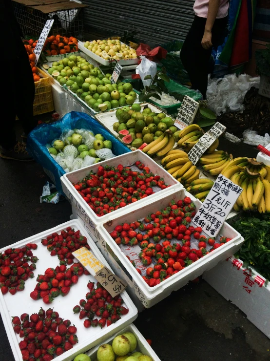a display of fruits and vegetables on the street