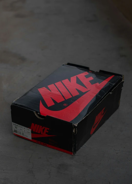 a box sits on the cement with the nike logo on it