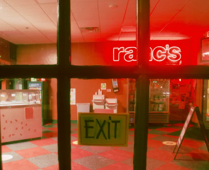 a large red exit sign next to the window