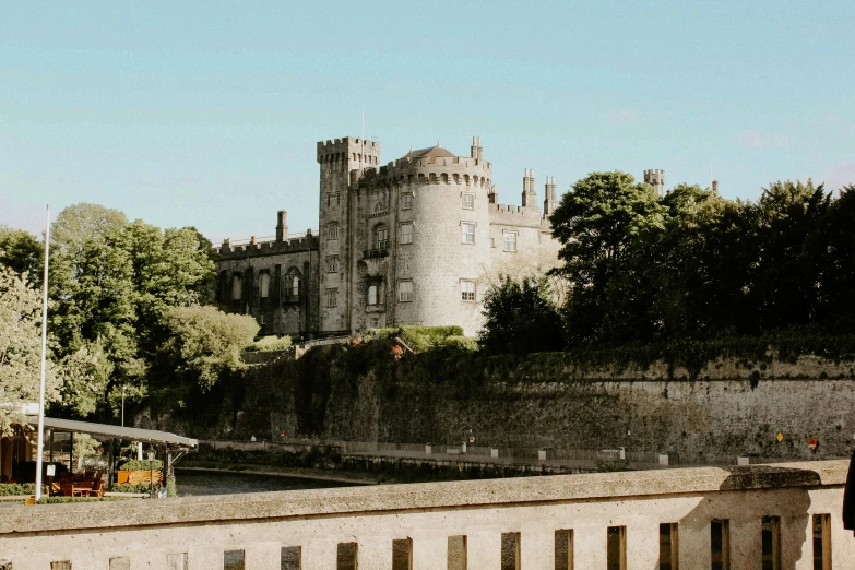 a castle with trees and shrubs surrounding it