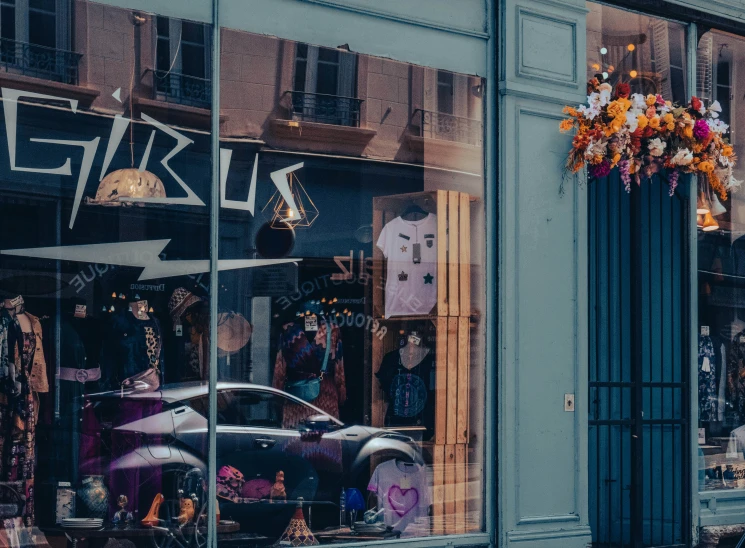 this is a store front with window reflection and an old car