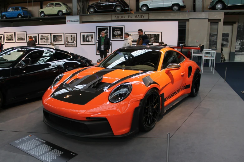 two race cars are on display in the showroom