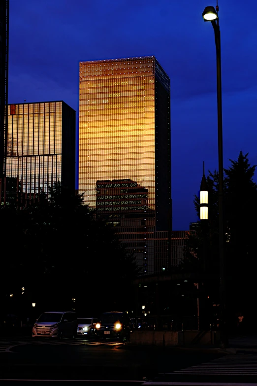 a large building lit up in the night with a traffic light