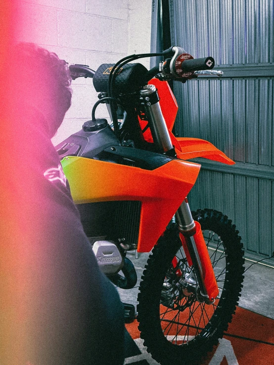 motorcycle sitting on top of a colorful floor