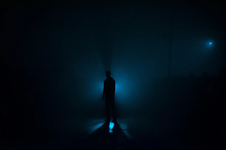 a person standing alone in the dark