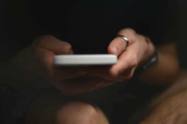 a person holding onto a remote control and finger to a on