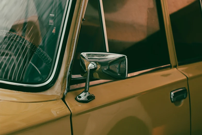 the side mirror is on a gold car