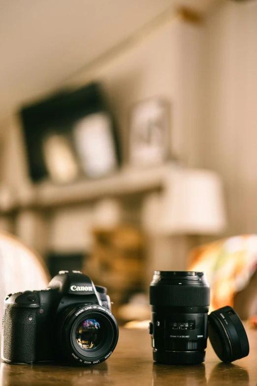 two camera's sit next to each other on a table