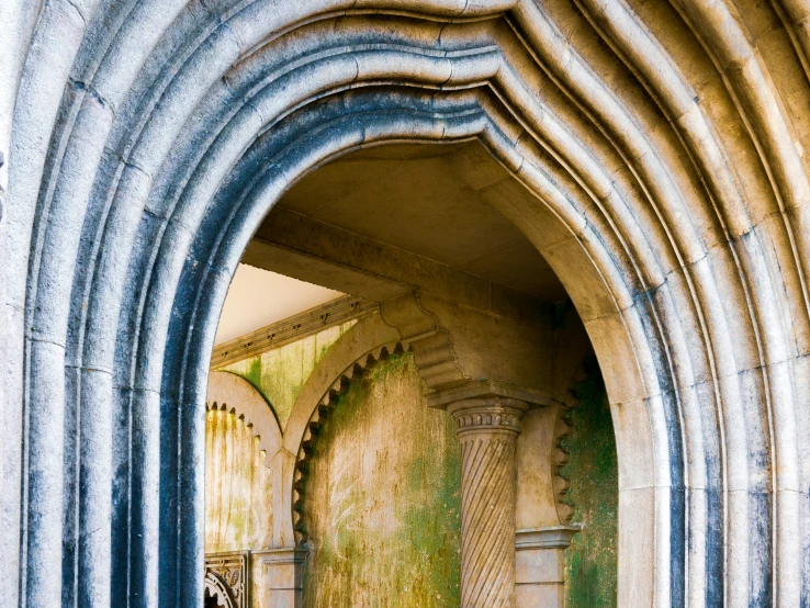 an archway with artistic designs inside of a building